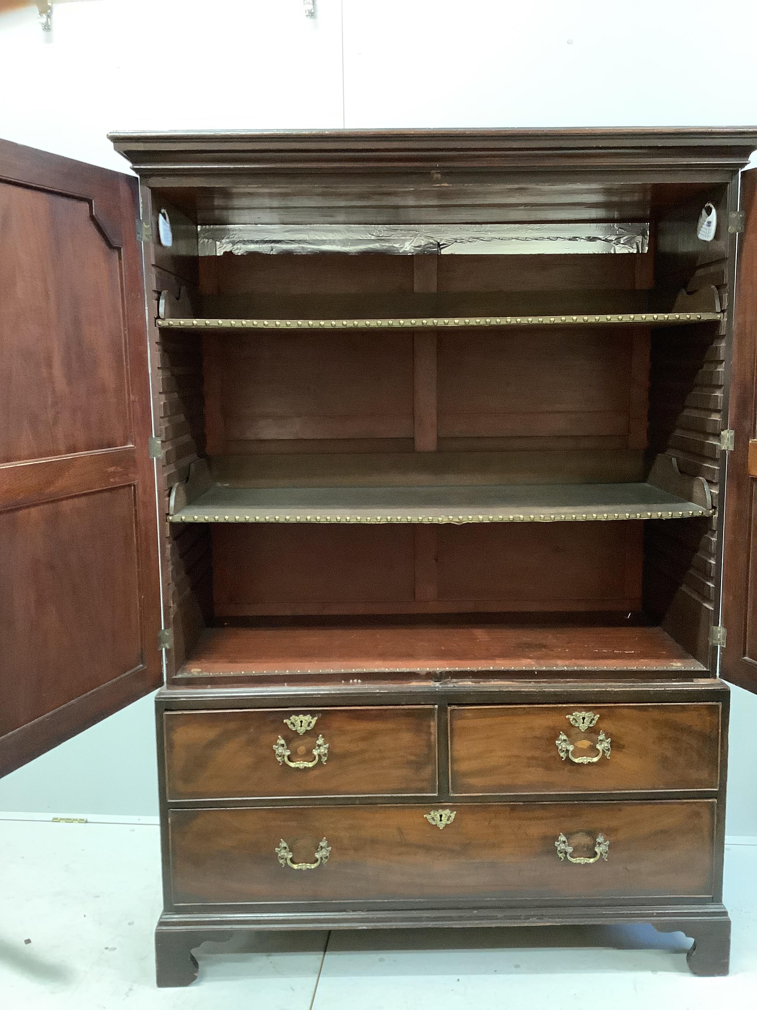 A George III mahogany press cupboard, width 130cm, depth 58cm, height 183cm